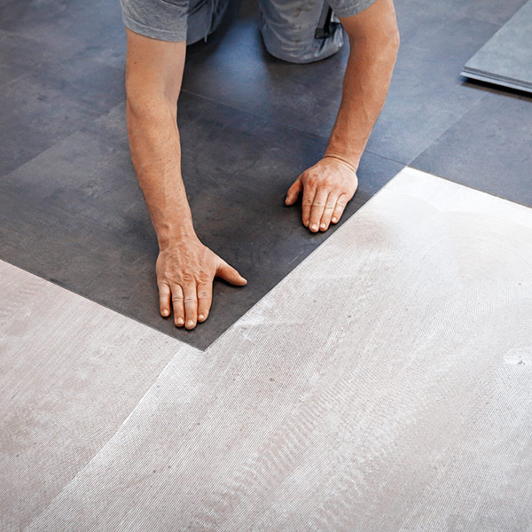 Man installing vinyl flooring